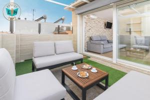 a living room with two chairs and a table at Luxury Home With Terrace in Málaga