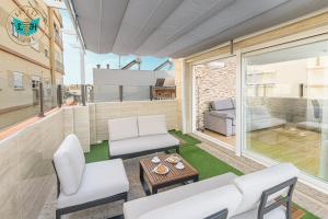 a living room with a couch and a table at Luxury Home With Terrace in Málaga