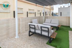 two chairs and a table on a patio at Luxury Home With Terrace in Málaga +38 photos