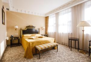a hotel room with a bed and a table and windows at Axelhof Boutique Hotel in Dnipro +136 photos
