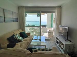 a living room with a couch and a view of the ocean at Apartamento Sea Views Las Redes in El Puerto de Santa María