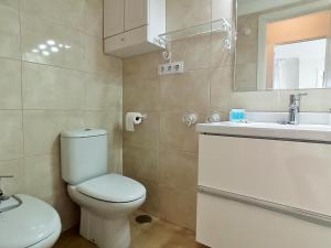 a bathroom with a white toilet and a sink at Apartamento Sea Views Las Redes in El Puerto de Santa María +24 photos