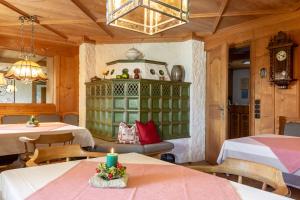 a room with two tables and a candle on a table at Pension Heim in Seeg