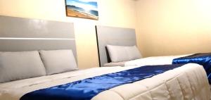 Postel nebo postele na pokoji v ubytování Pearl Point Hotel