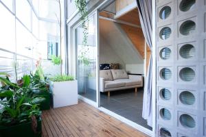 a living room with a couch and some plants at Soc House 1 in Vung Tau