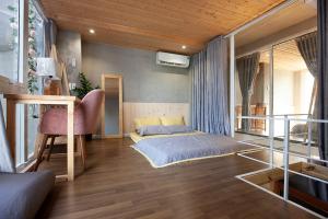 a bedroom with a bed and a chair in it at Soc House 1 in Vung Tau