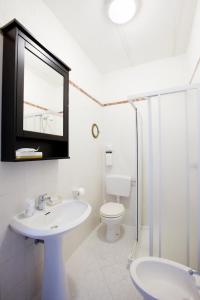 uma casa de banho com um lavatório, um WC e um espelho. em NORMA em Levanto