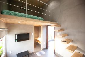 a room with a loft with a bed and a tv at Soc House 1 in Vung Tau