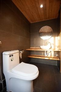 a bathroom with a white toilet and a sink at Soc House 1 in Vung Tau +32 photos
