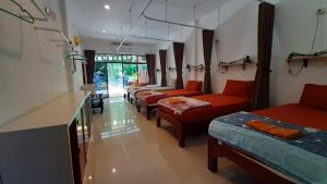 a room with four beds and couches in it at Runa Runa The Best Samed Island in Ko Samed