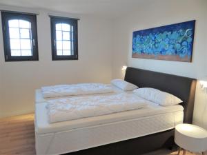 a bedroom with a white bed with two pillows at Speicher Residenz Barth E4 App 7 in Barth