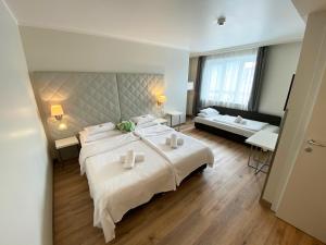 a large bedroom with a large bed and a couch at Safestay Vienna Margaretenviertel in Vienna