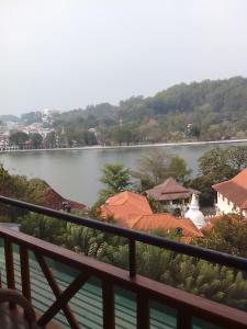 a view of a lake from a balcony at Heaven Seven Kandy in Kandy