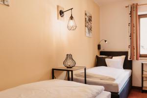 Postel nebo postele na pokoji v ubytování Alte Schmiede - das kleine Hotel