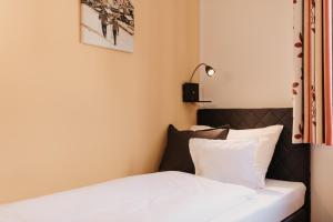 Postel nebo postele na pokoji v ubytování Alte Schmiede - das kleine Hotel