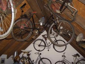 a group of bikes are hanging in a attic at Die Radler-Scheune in Burg