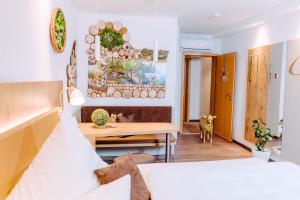 a room with a bed and a desk and a table at Garni-Hotel Goldenes Lamm in Speyer +41 photos