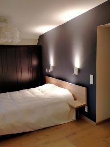 Säng eller sängar i ett rum på L'Aubergine