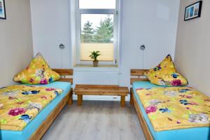 a room with two beds and a window at Ferienwohnung Ostard 1 in Thale