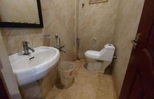 a bathroom with a sink and a toilet at Royal Grand in Tambaram +30 photos