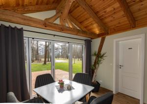 a dining room with a white table and chairs at Pension Lukask in Burg