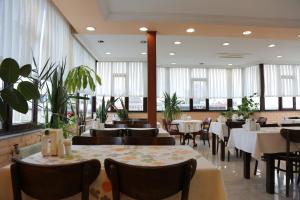 a dining room with tables and chairs and windows at EMOS HOTEL in Istanbul