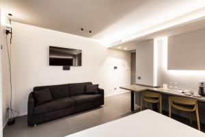 a living room with a couch and a table at RB del Teatro&Apartaments in Imola