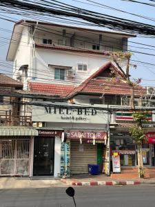 a store on the side of a street next to a building at MIEL BED Hostel & Gallery in Chiang Mai