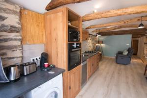 una cucina con mobili in legno e un piano di lavoro di Gites des Esperelles a Saint-Privat-de-Vallongue