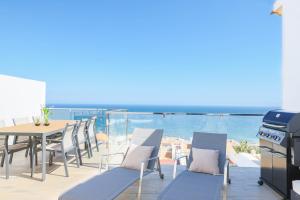 a patio with a table and chairs and the ocean at Stay In Carabassi II in Gran Alacant