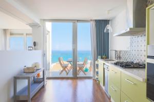 a kitchen with a view of the ocean at Stay In Carabassi II in Gran Alacant