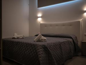 a bedroom with a bed with two pillows on it at Resilienza Apartment in Capo dʼOrlando