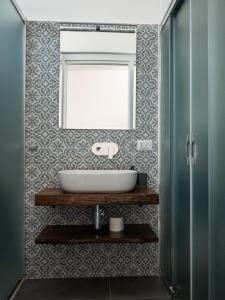 a bathroom with a sink and a mirror at Resilienza Apartment in Capo dʼOrlando