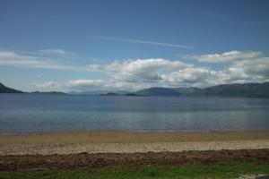 a large body of water with mountains in the background at Mingulay, Cuil Bay in Appin +5 photos