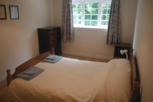 a bedroom with a large bed with a window at Mingulay, Cuil Bay in Appin