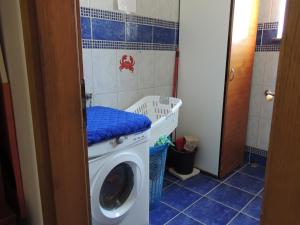 a laundry room with a washing machine in a bathroom at Apartments Mijic in Medulin