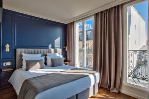 a bedroom with a large bed and a large window at Maison Barbès in Paris +48 photos