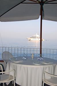 a table with a cruise ship in the ocean at Hotel Lido Mediterranee in Taormina