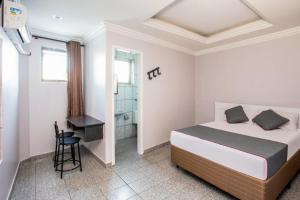 Un pat sau paturi într-o cameră la Hotel Tiquatira - Zona Leste