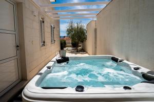 a jacuzzi tub in the middle of a building at Apartments Villa Azzurra Bol in Bol