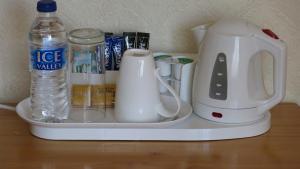 a coffee maker and other items on a shelf at Broadwell Guest House in Meriden