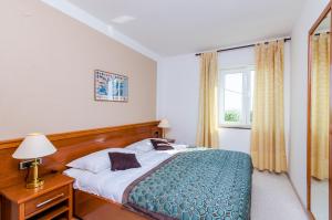 a bedroom with a bed and a window at Apartments Nicol in Dubrovnik