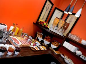 a buffet with many different types of food on a table at Hotel Victoria Lyon Perrache Confluence in Lyon