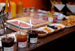 a buffet with different types of food on a table at Hotel Victoria Lyon Perrache Confluence in Lyon