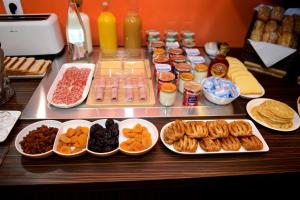 a table with many different types of food on it at Hotel Victoria Lyon Perrache Confluence in Lyon