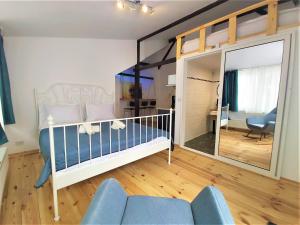 a baby crib in a room with a mirror at 92 Residence in Braşov