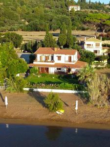 an aerial view of a house on the water at Alekos Beach Houses-Alekos Beach Complex in Lixouri