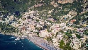 
a large body of water with buildings at La sorgente del sole in Positano
