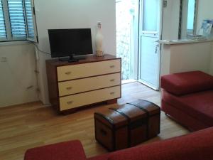 a living room with a dresser with a tv on it at Old Harbour City Center Apartment in Dubrovnik
