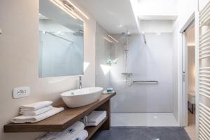 a bathroom with a sink, toilet and bathtub at Hotel Continental - TonelliHotels in Nago-Torbole